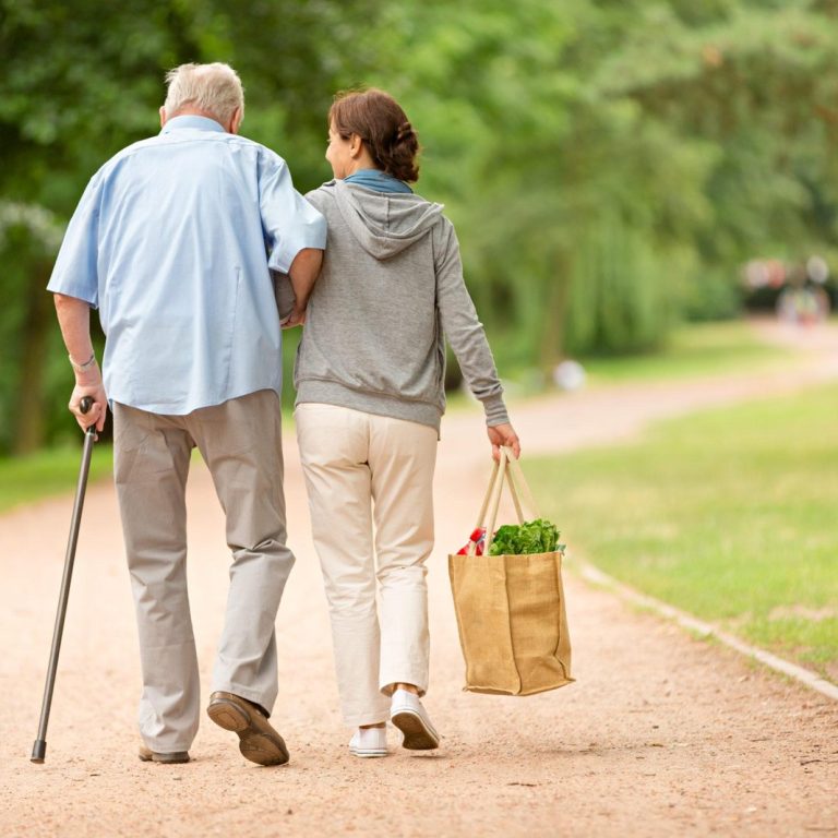 Caregiver – woman helping senior man with shopping