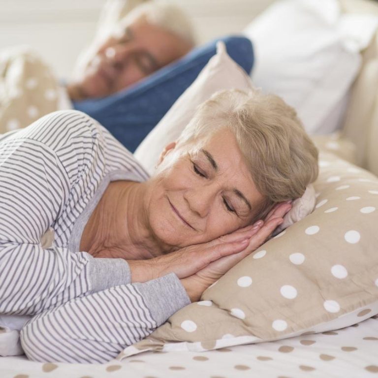 Woman and her husband sleeping comfortably
